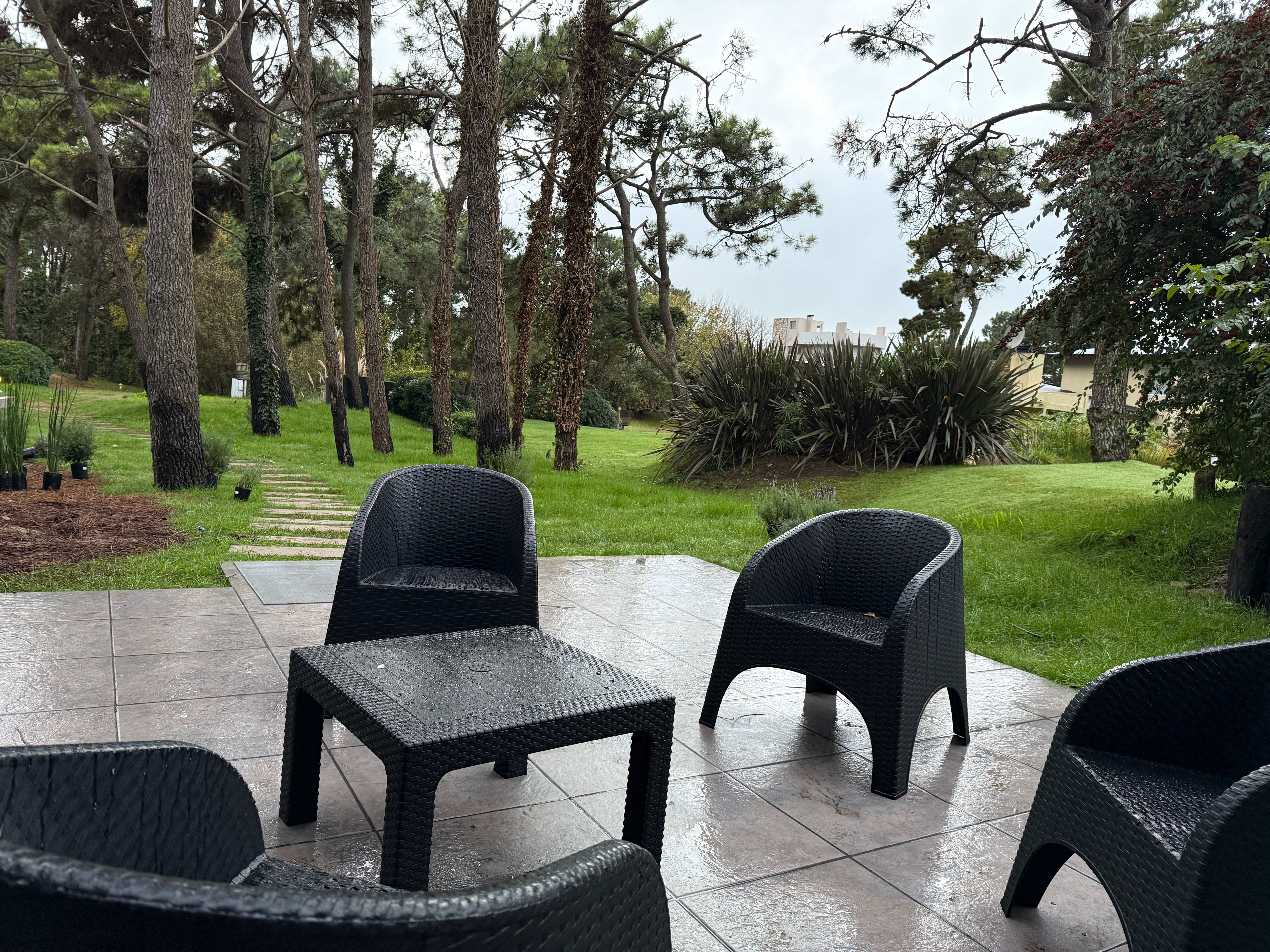 Outdoor seating area with modern furniture and landscaped garden